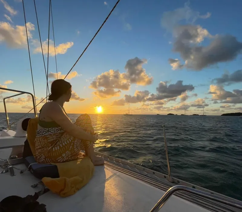 Private sailing catamaran anchored over a clear turquoise reef on an antigua and barbuda snorkeling charter from Jolly Harbour