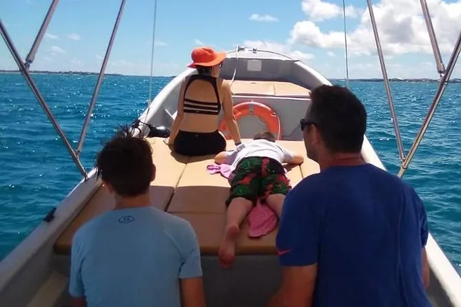 Private boat anchored over a calm turquoise reef on an exclusive antigua and barbuda snorkeling charter near Jolly Harbour